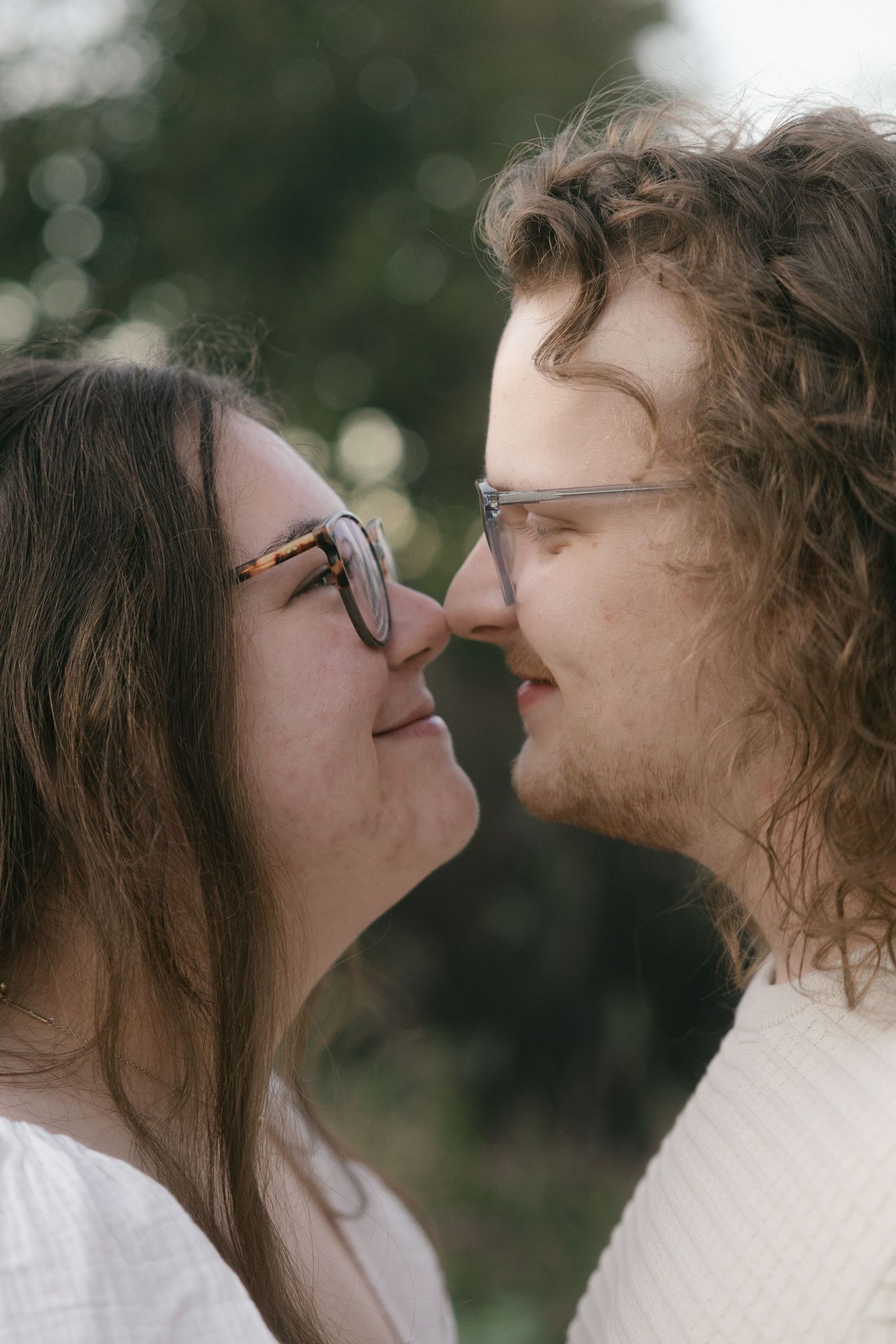 A romantic couple shares intimate close-up moments in a series of tender kisses against a soft blurred background.