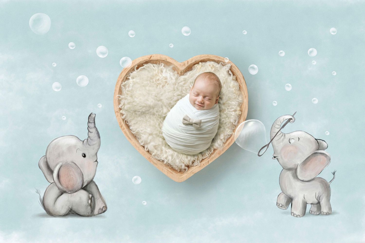 Newborn baby sleeping in heart-shaped bowl surrounded by cute cartoon elephants on a soft blue background.