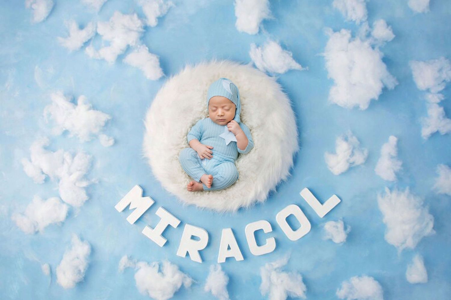 Newborn baby in blue outfit sleeping in white fluffy nest with MIRACOL letters on light blue background with feathers.