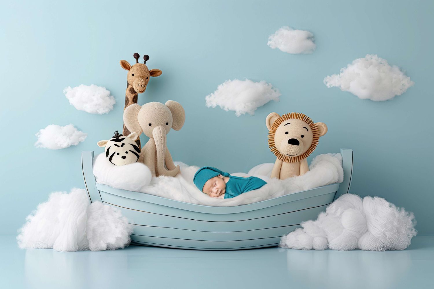 Newborn baby sleeping in a toy boat with stuffed animal giraffe, elephant, zebra, and lion on a blue background.