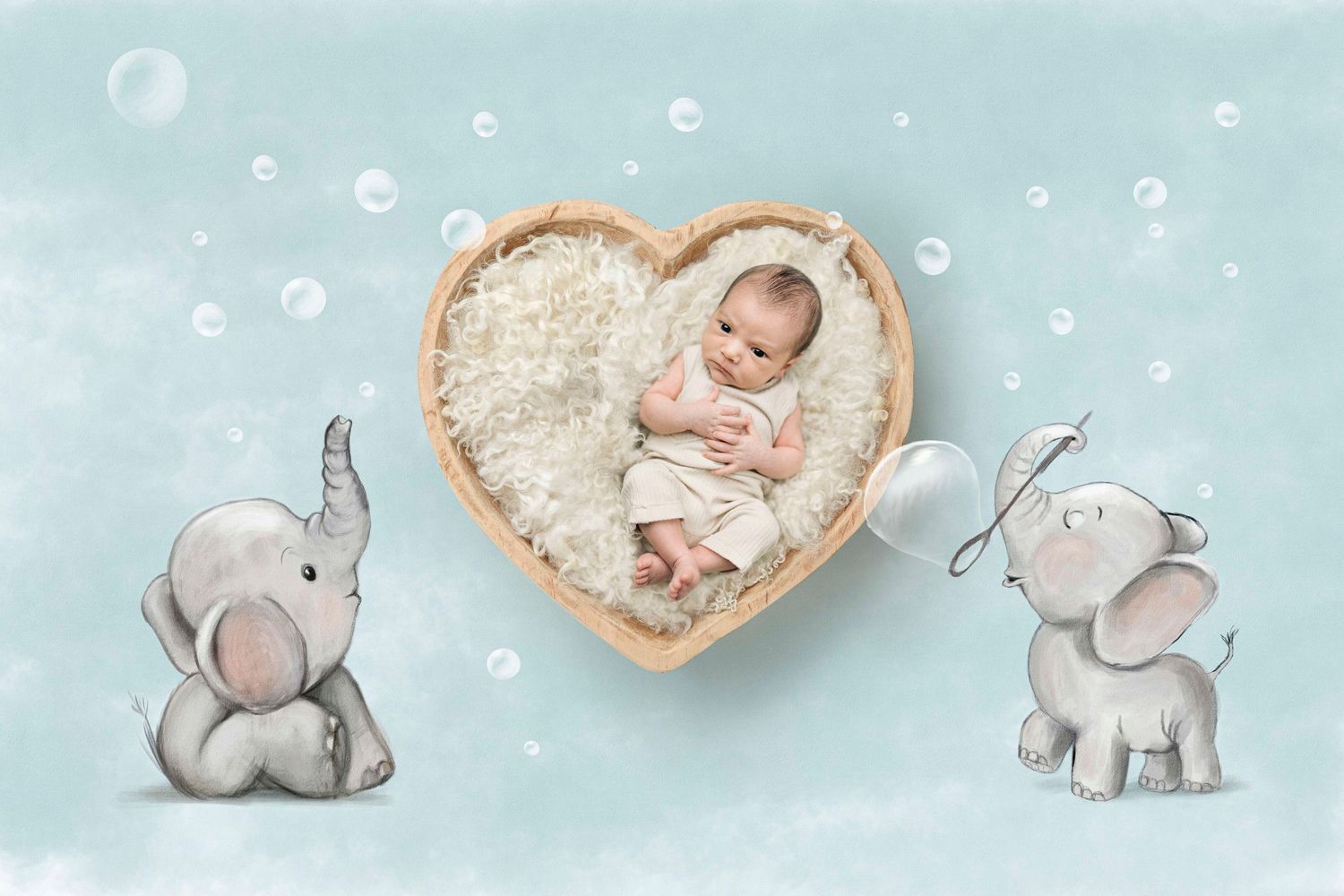 Newborn baby sleeping in heart-shaped wooden bowl surrounded by cartoon elephants on soft blue background.