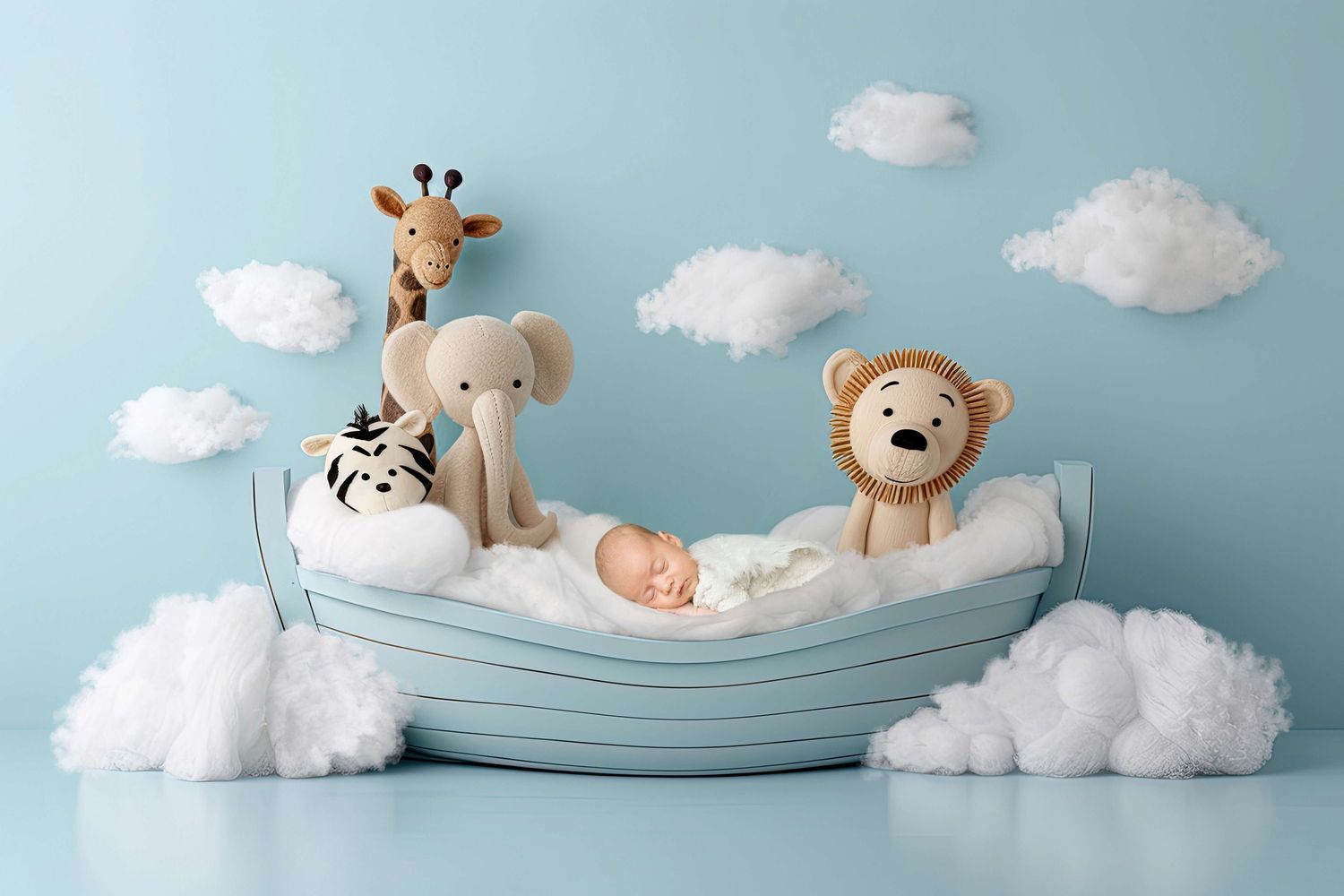 Newborn baby sleeping in a light blue boat with stuffed animal toys giraffe elephant tiger and lion on blue background.