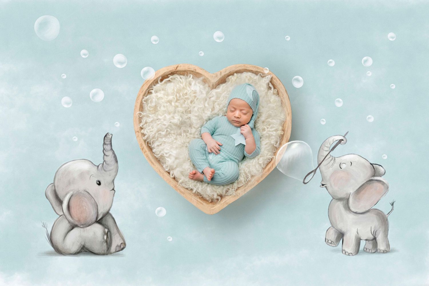 Newborn baby sleeping in heart-shaped basket with fluffy white lining, flanked by cute cartoon elephants on teal background.