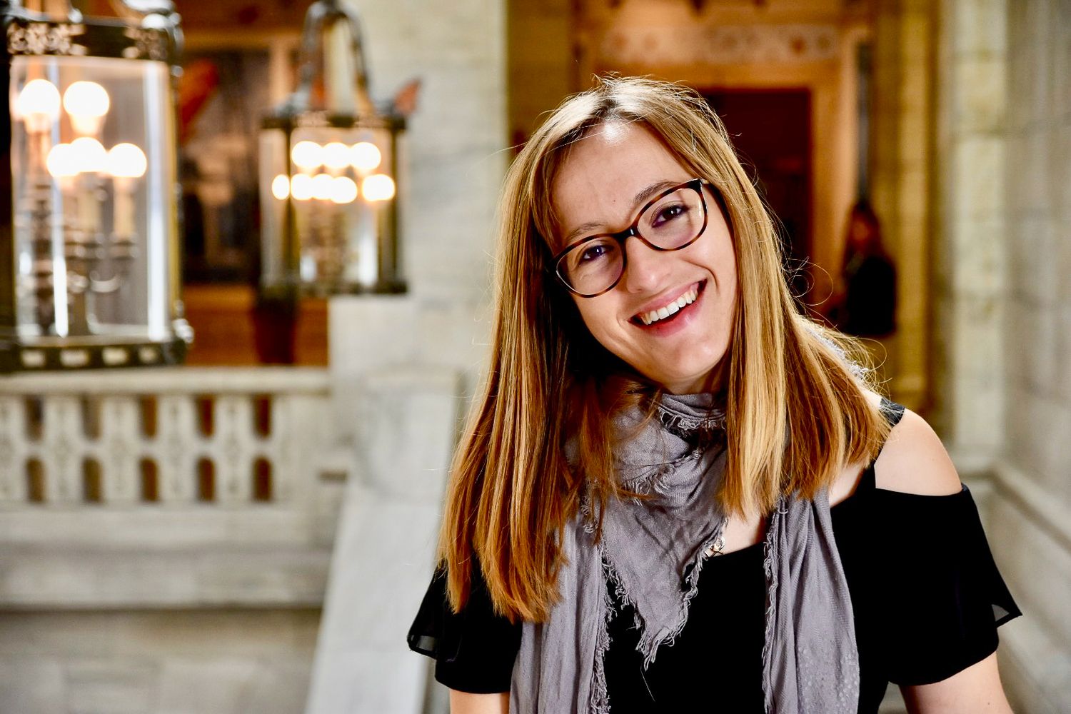 Portrait d'une femme souriante dans un bâtiment ancien à Langon, en Sud-Gironde