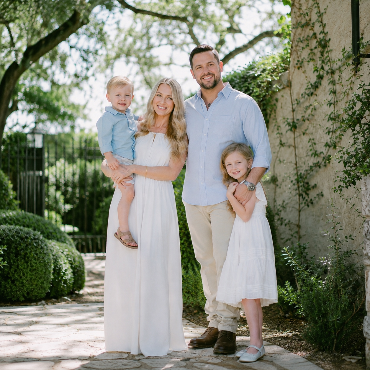 Parents with their young children during a luxury family portrait session at Laguna Gloria in Austin, Texas.