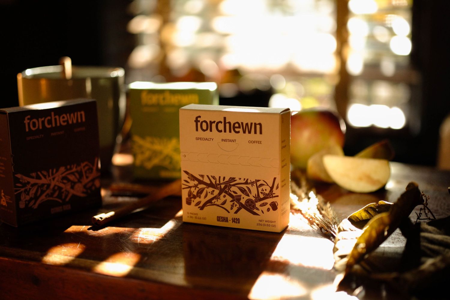 Coffee packages and ceramic cup photographed in patterned window light.