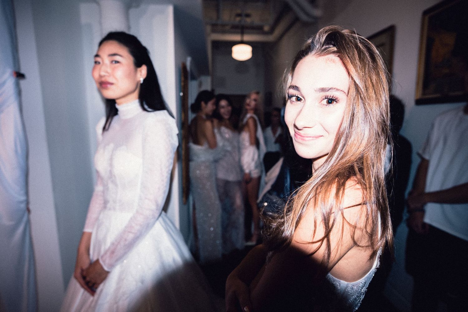 Stylish guest looking toward the camera inside a Soho fashion event.