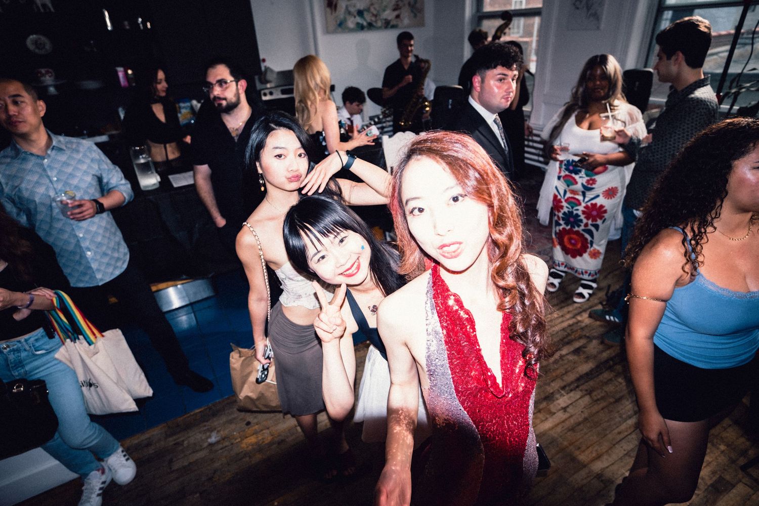 Fashion-event guests posing for a lively group photograph.