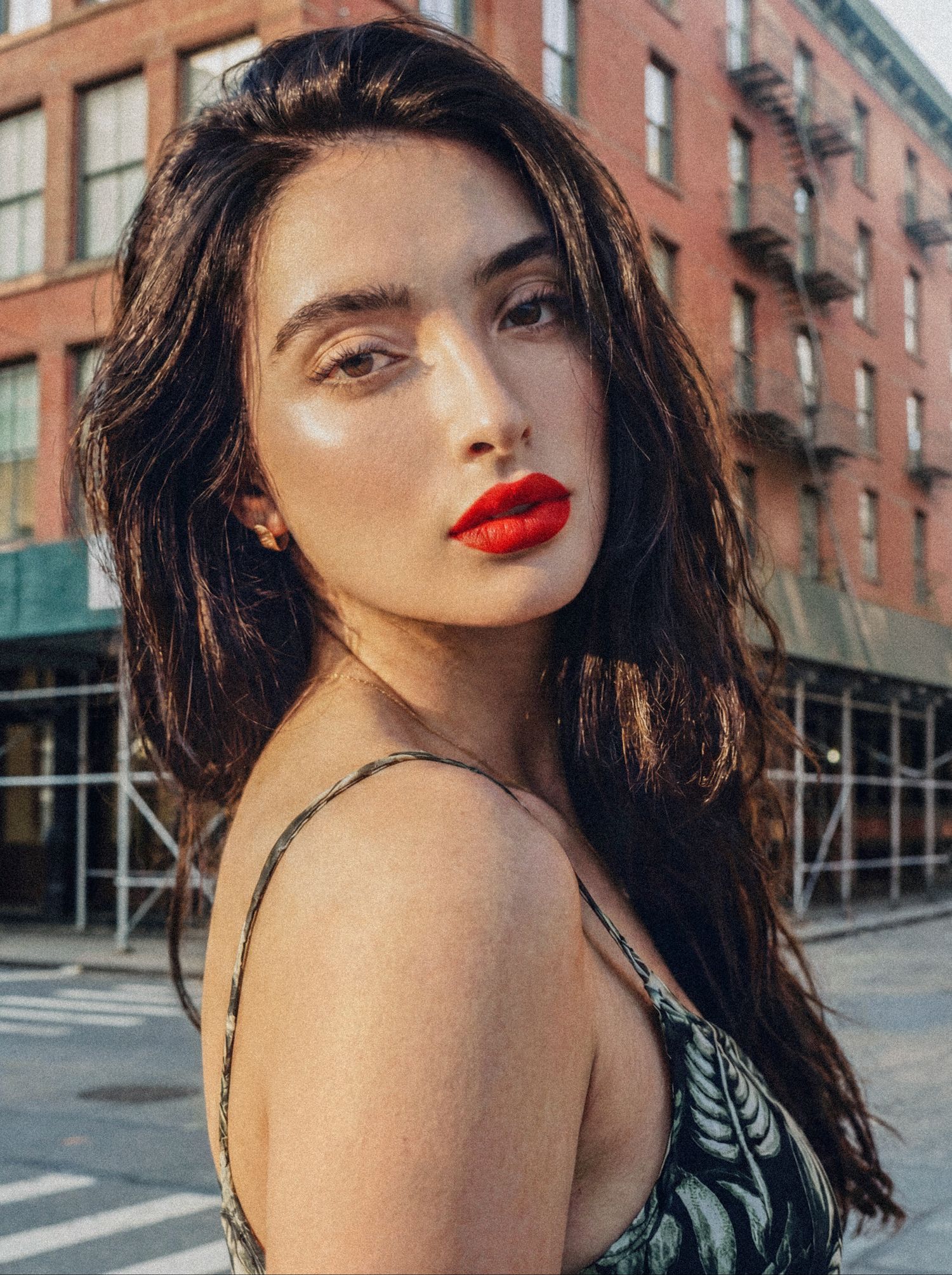 Outdoor editorial portrait of a woman against a New York City streetscape.