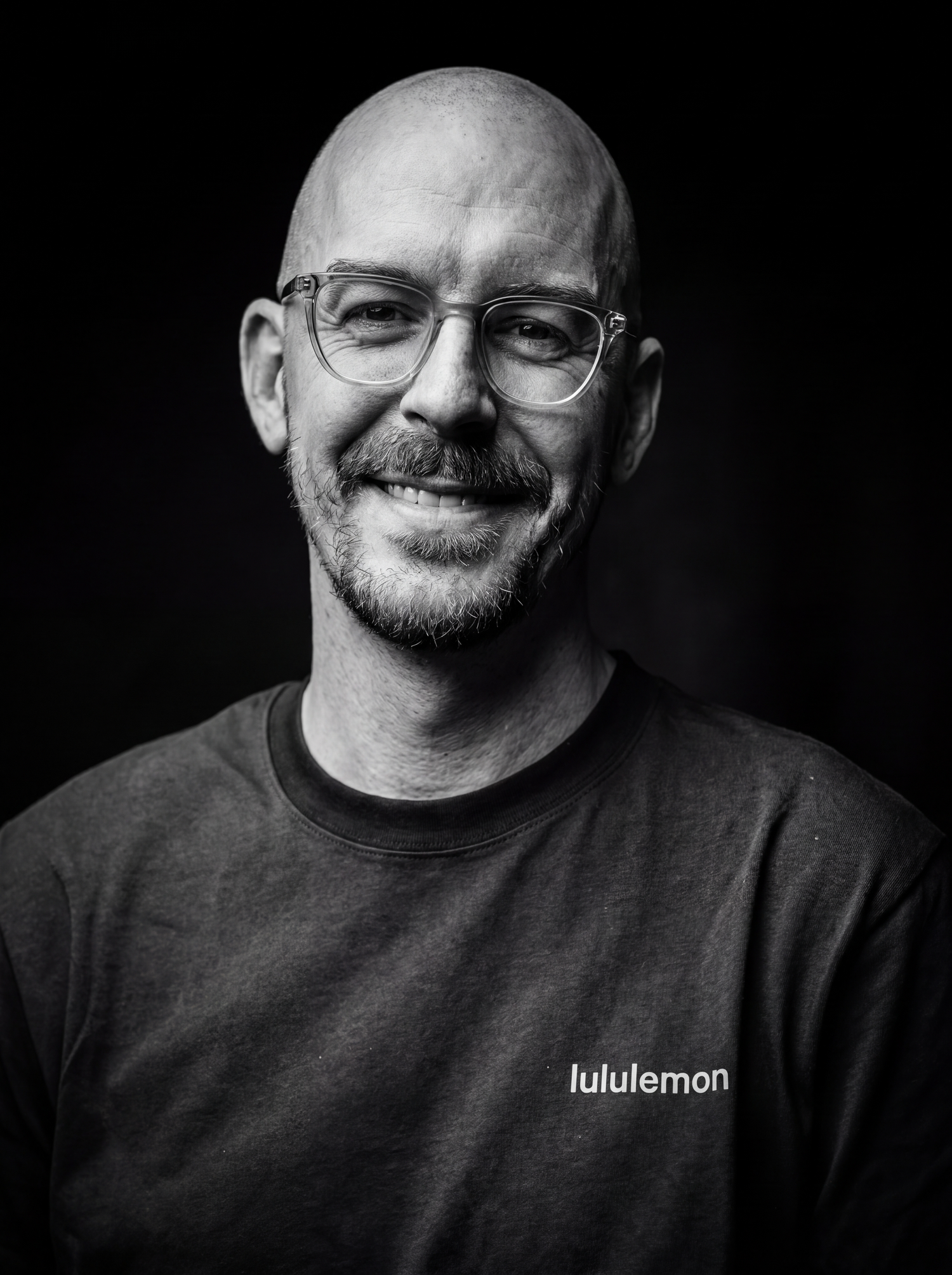 Black-and-white portrait of photographer Justin Von Braun smiling.