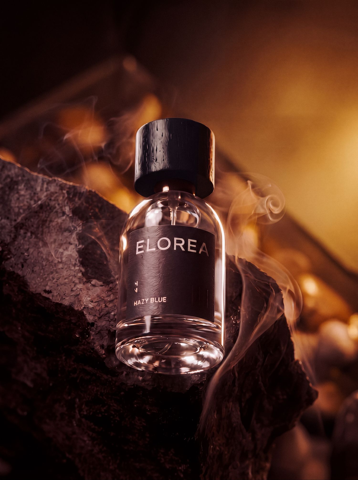Luxury black fragrance bottle photographed in warm amber light.