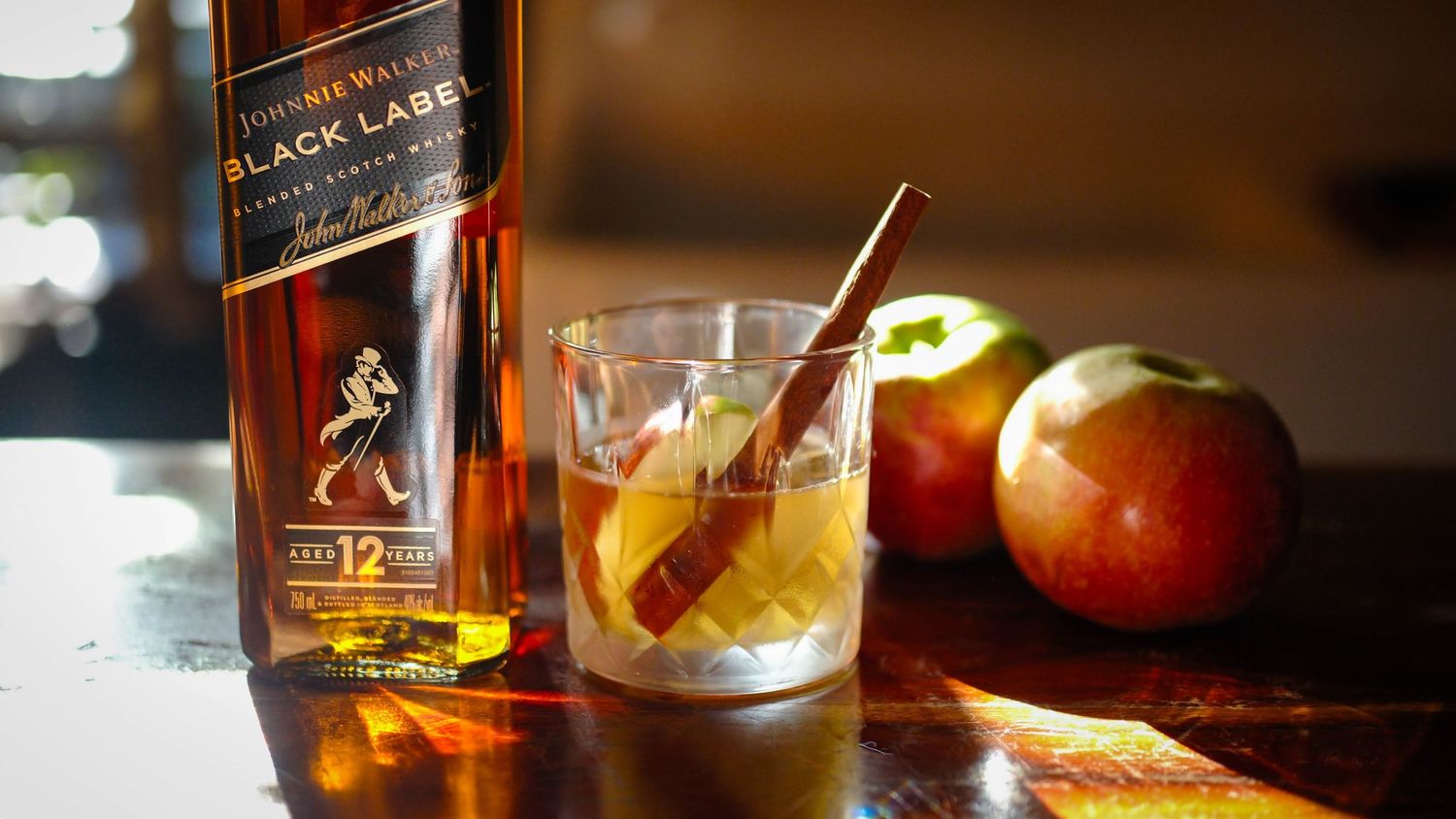 Johnnie Walker Black Label bottle with a cocktail and autumn apples.