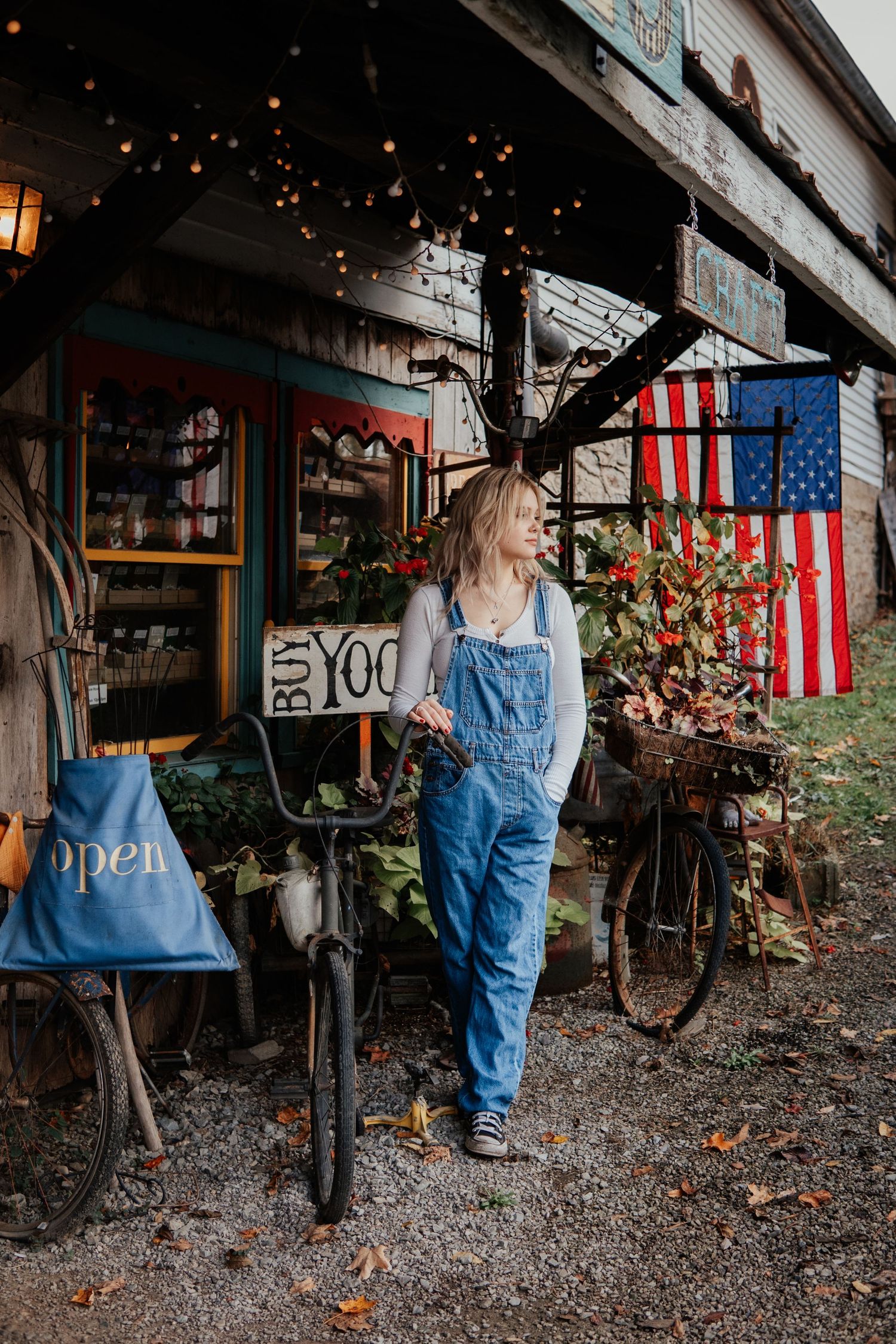Vintage American scene with denim overalls against rustic storefront and American flag.