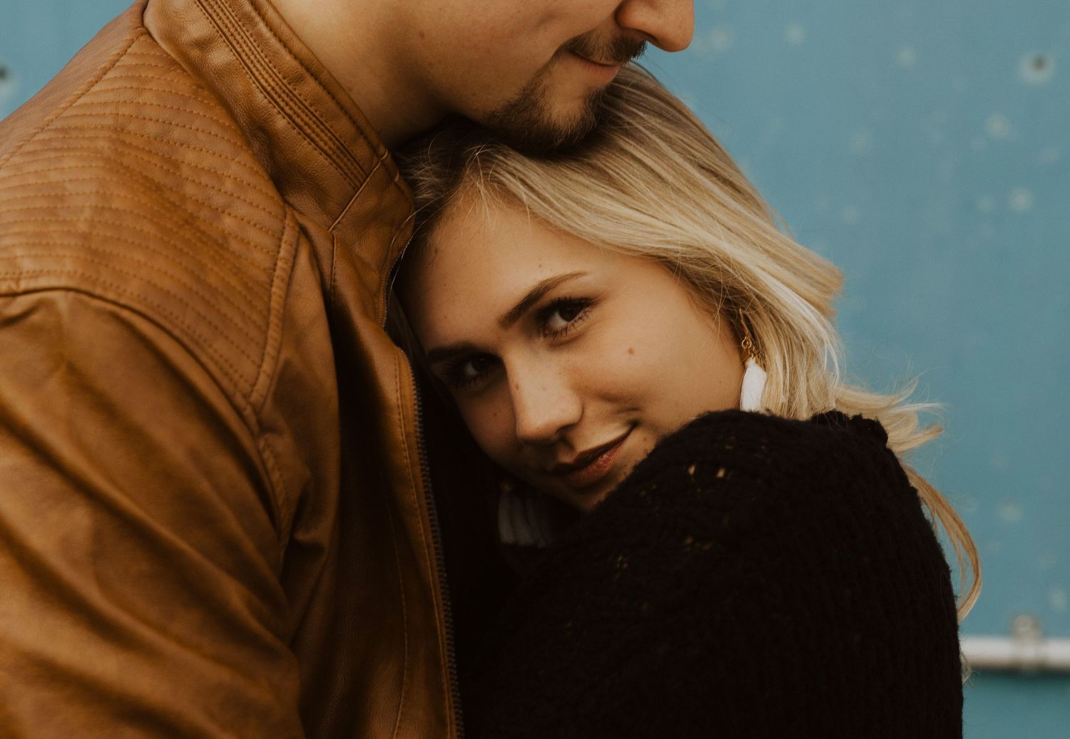 Close-up photo series showing tender moments between a couple against a blue background.