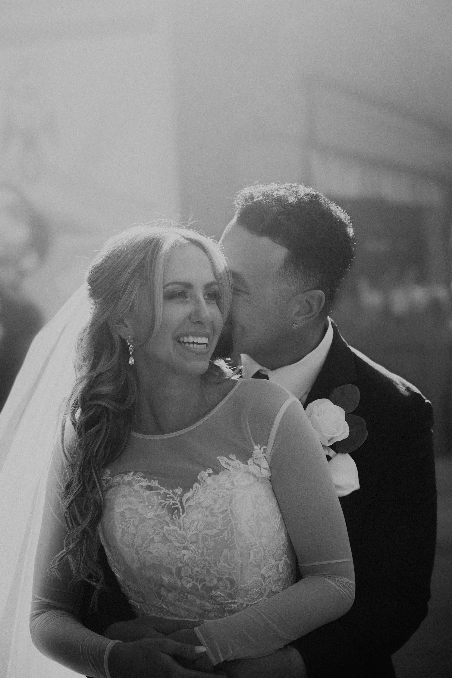 Intimate black and white wedding portrait capturing joy and romance.