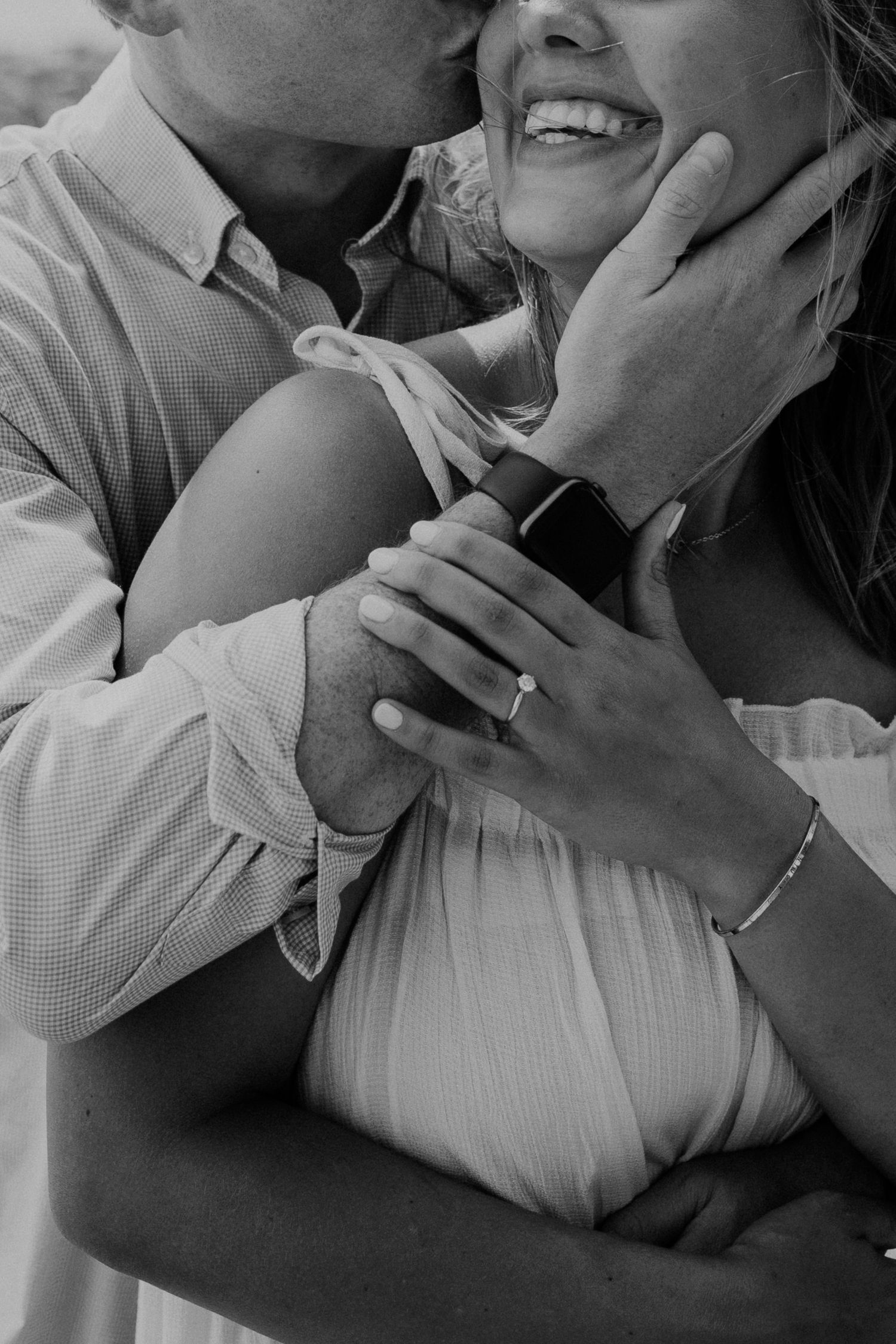 Close-up black and white photo of couple sharing intimate moment together.
