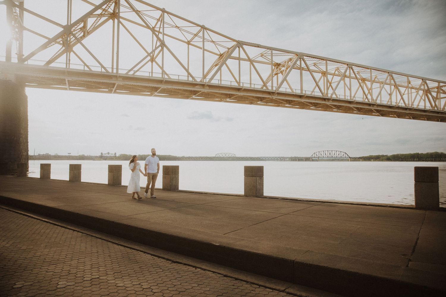 Industrial bridge architecture spans across a waterfront scene.
