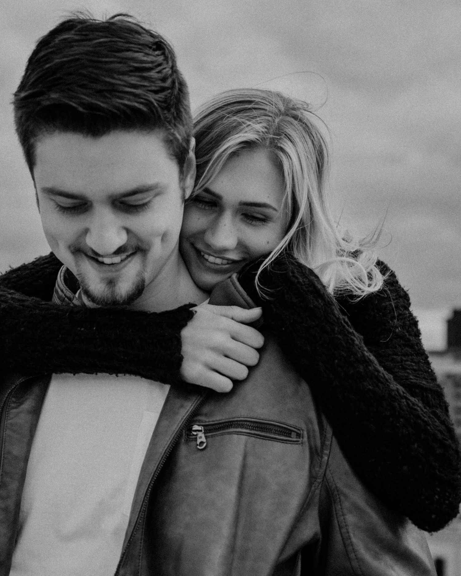 A black and white photo sequence of a couple sharing playful moments together.
