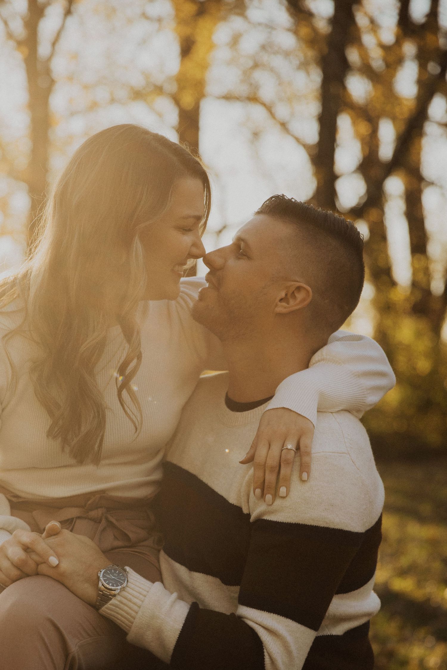 A romantic couple sharing tender moments in golden autumn sunlight.