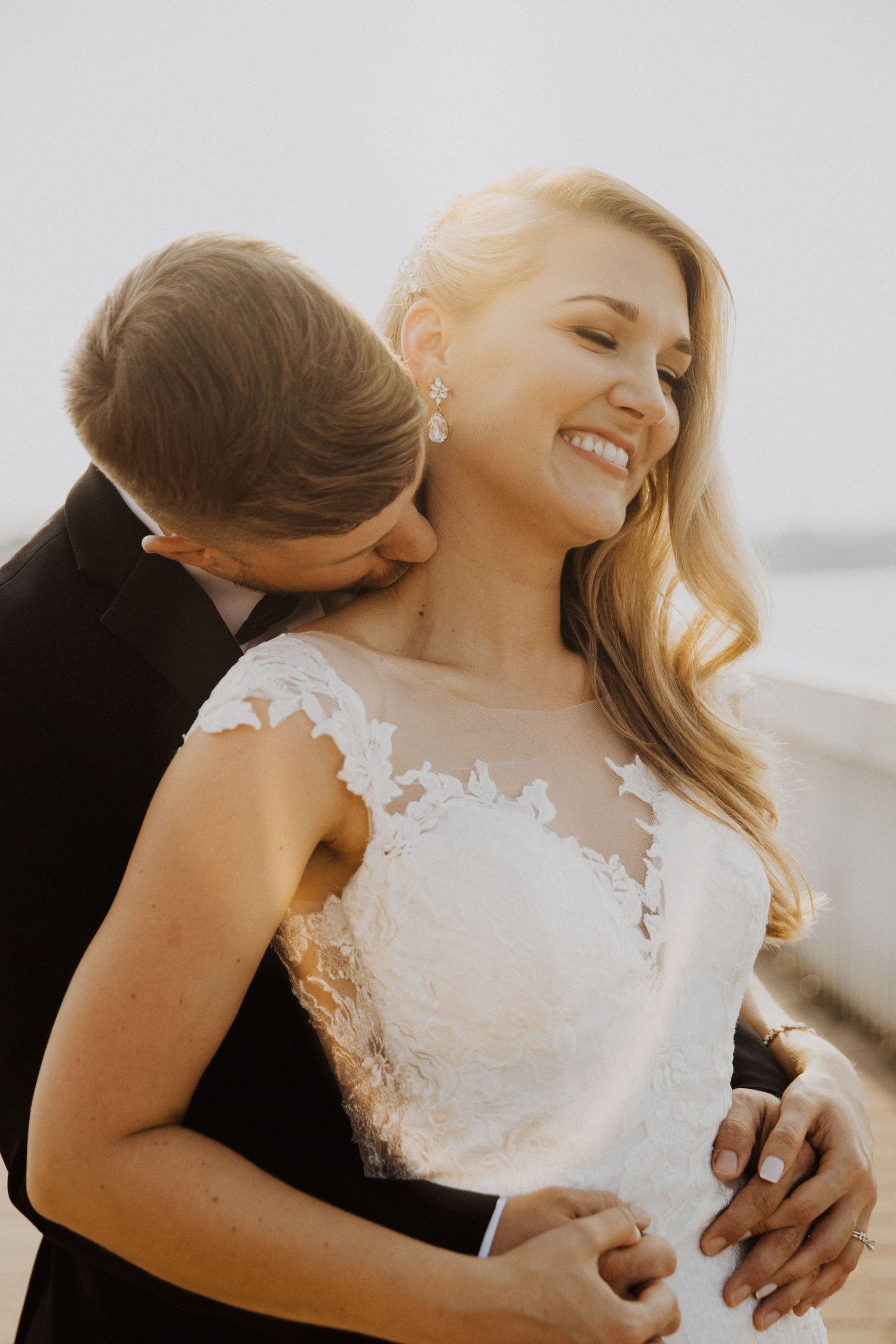 Candid moments of bride in lace dress during outdoor photoshoot.