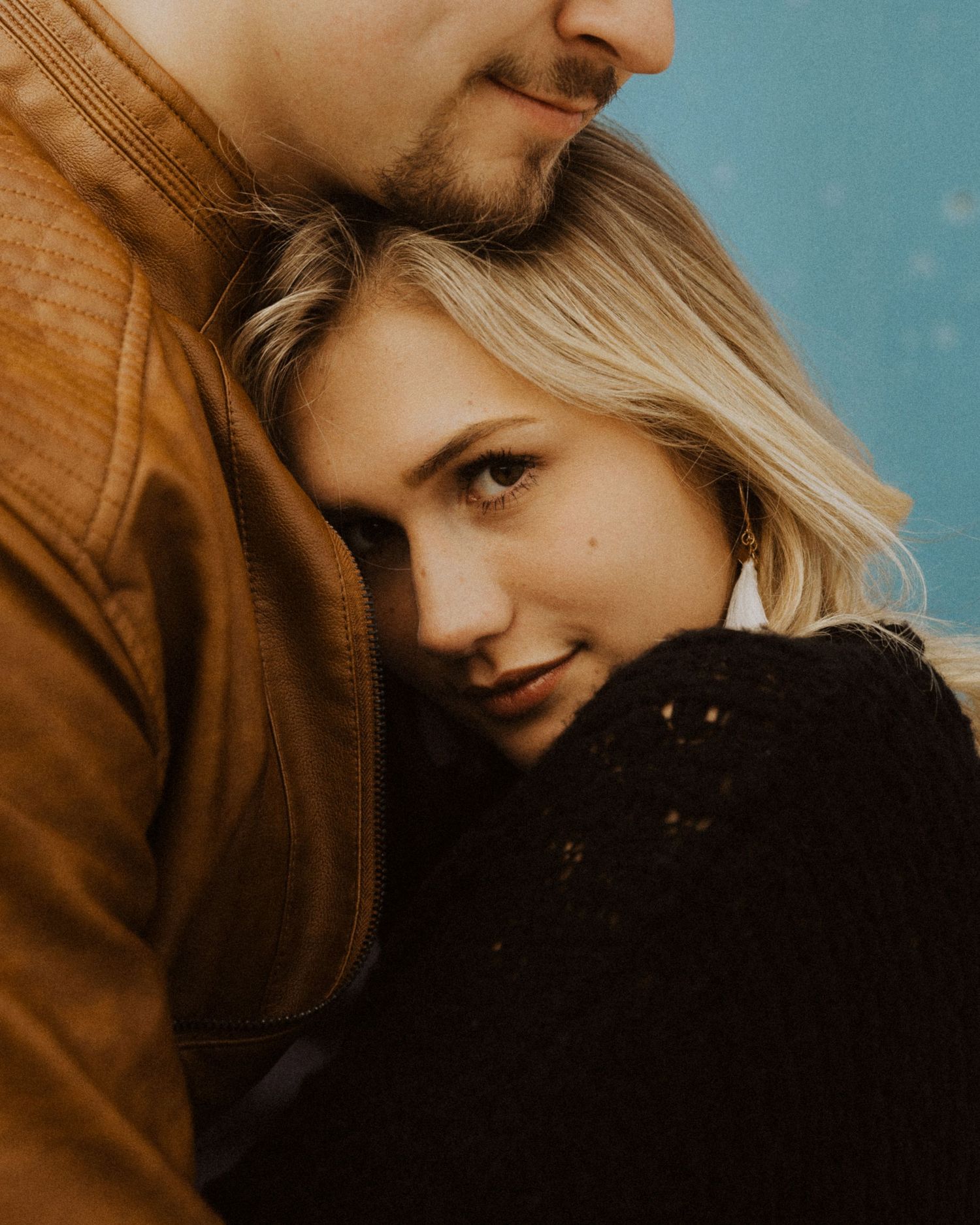 Intimate portrait series showing tender moments between a couple in warm tones.