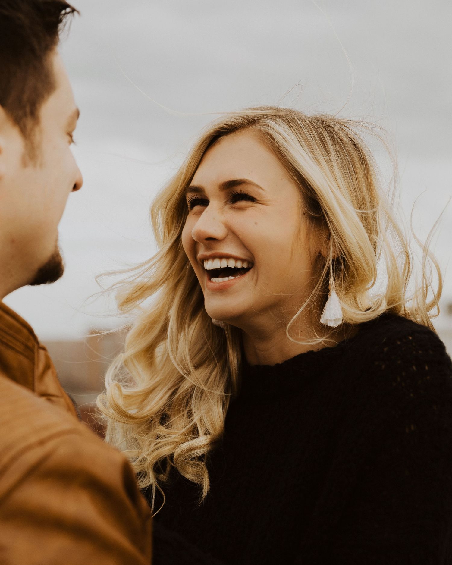 A warm-toned photo sequence capturing joyful moments between a couple.