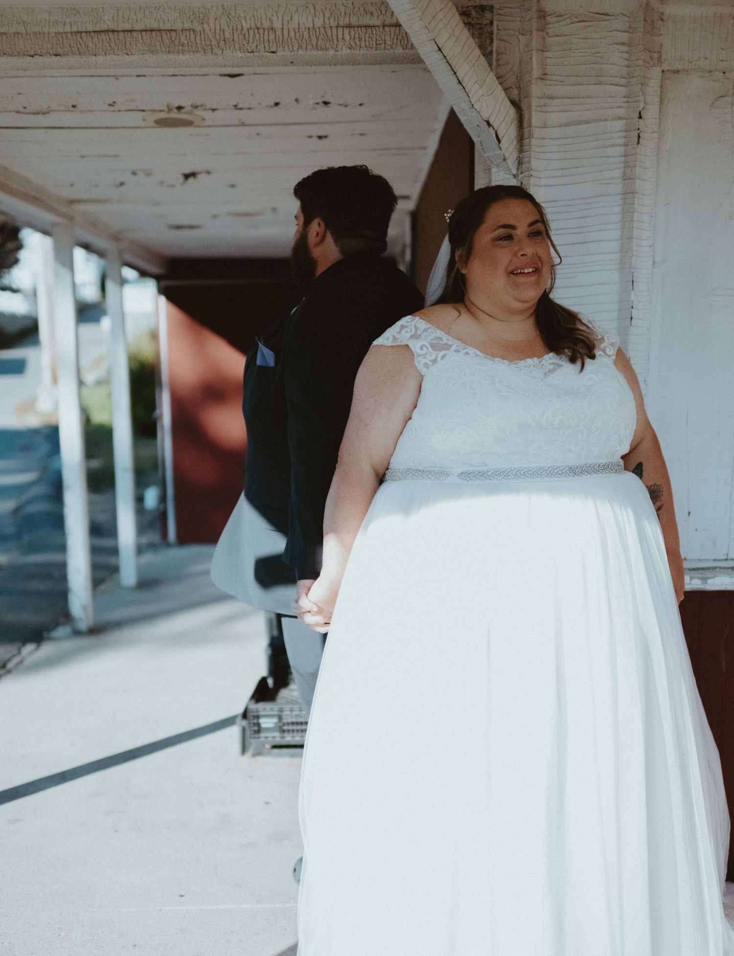 Bride in lace cap-sleeve wedding gown share 