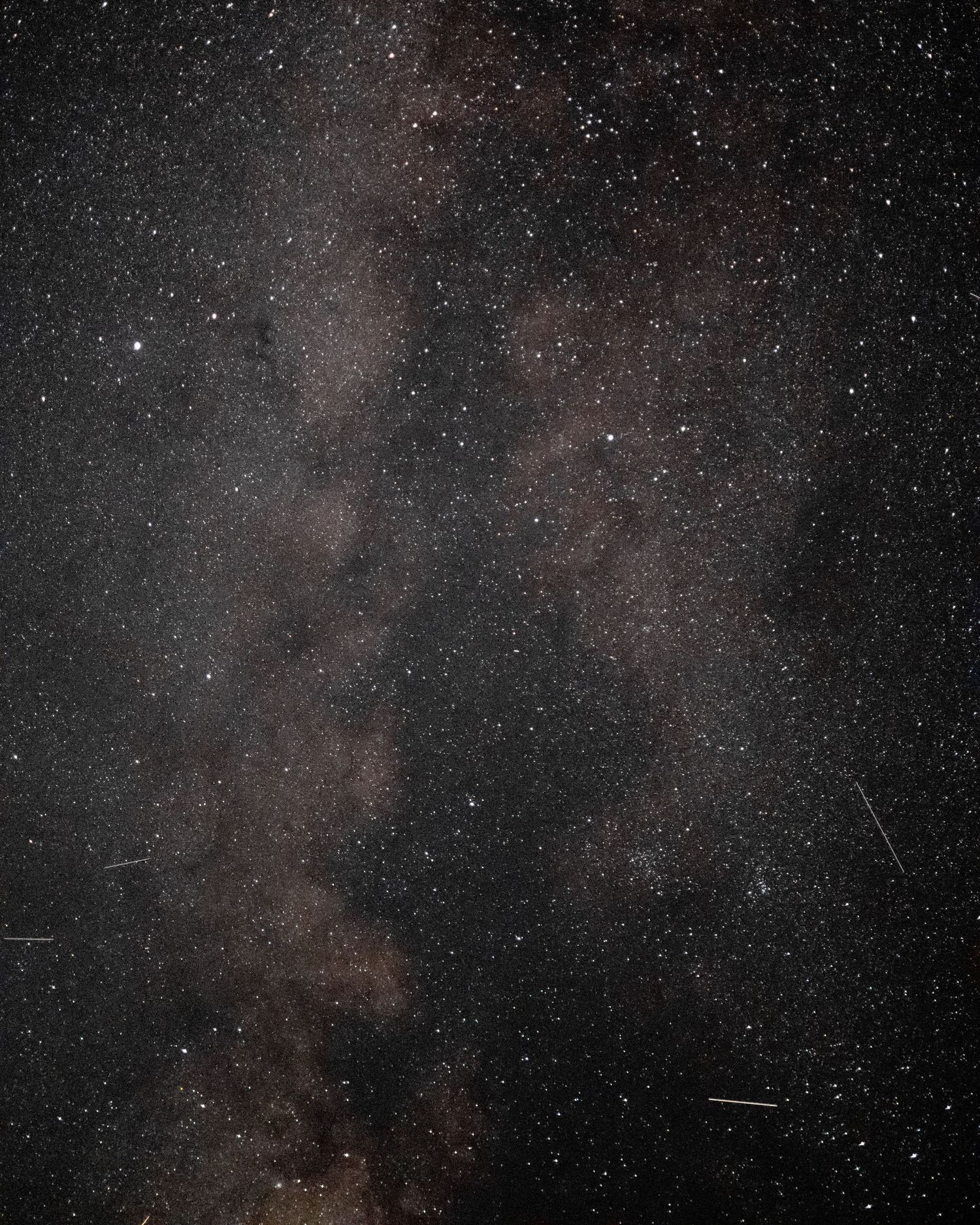 A stunning wide-angle photograph of the Milky Way galaxy core, revealing thousands of stars and cosmic dust clouds in the night sky.