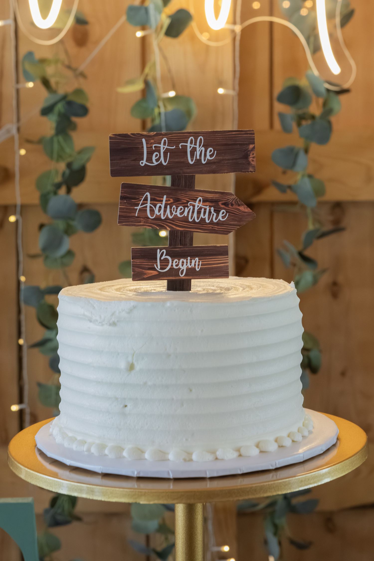 White wedding cake with rustic wooden 