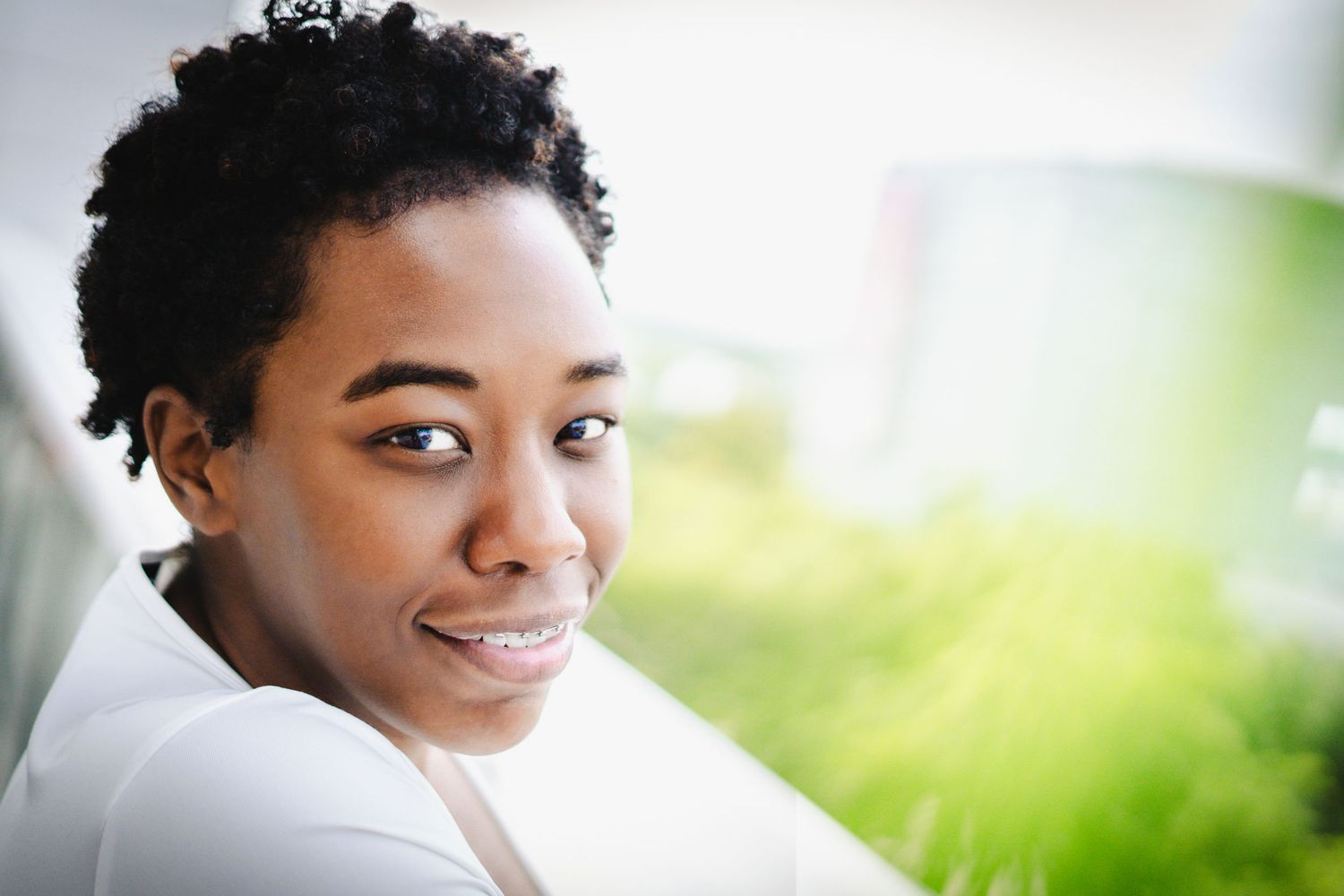 Natural light portrait with soft bokeh background and gentle expression.
