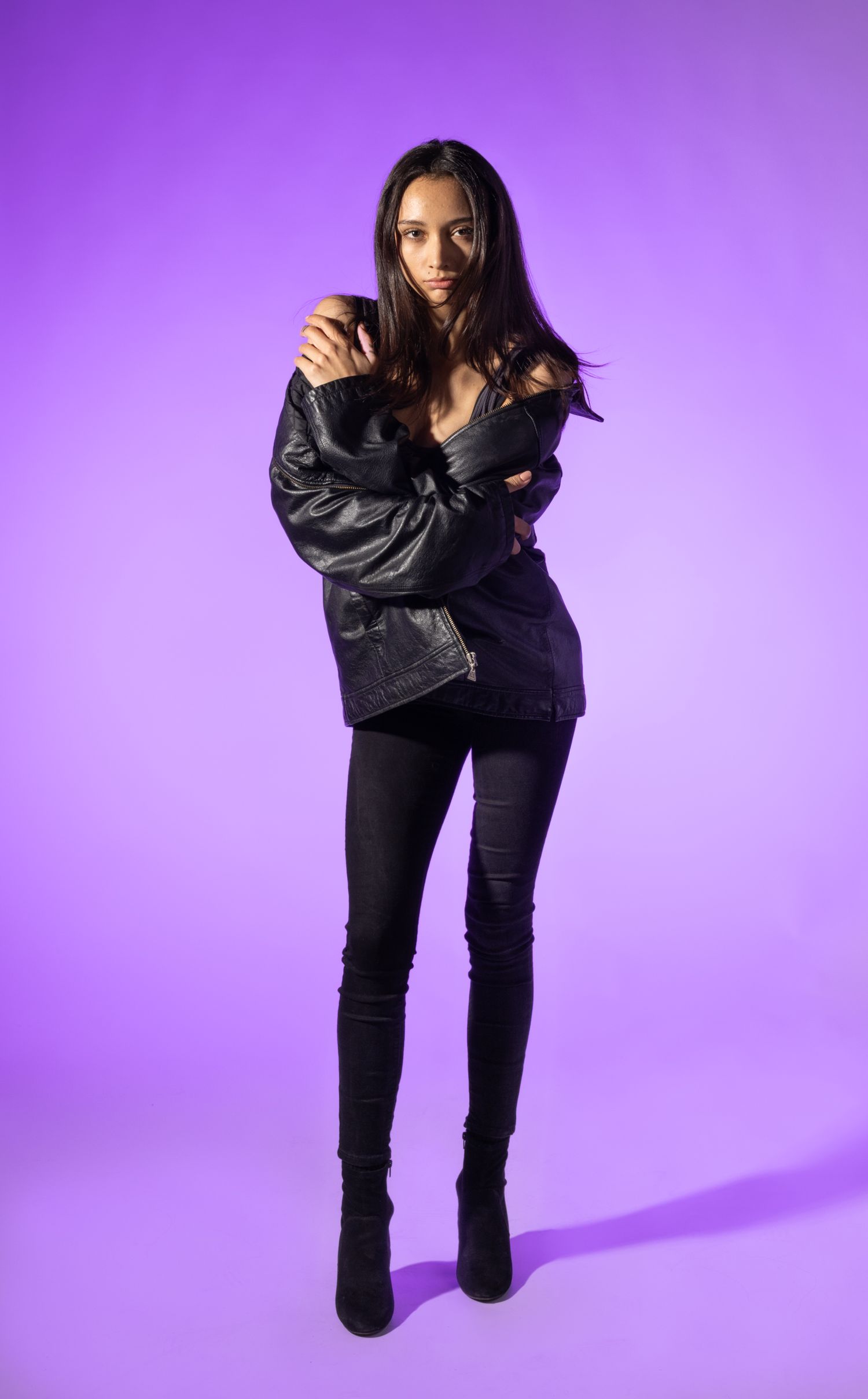 Female model posed in front of purple background