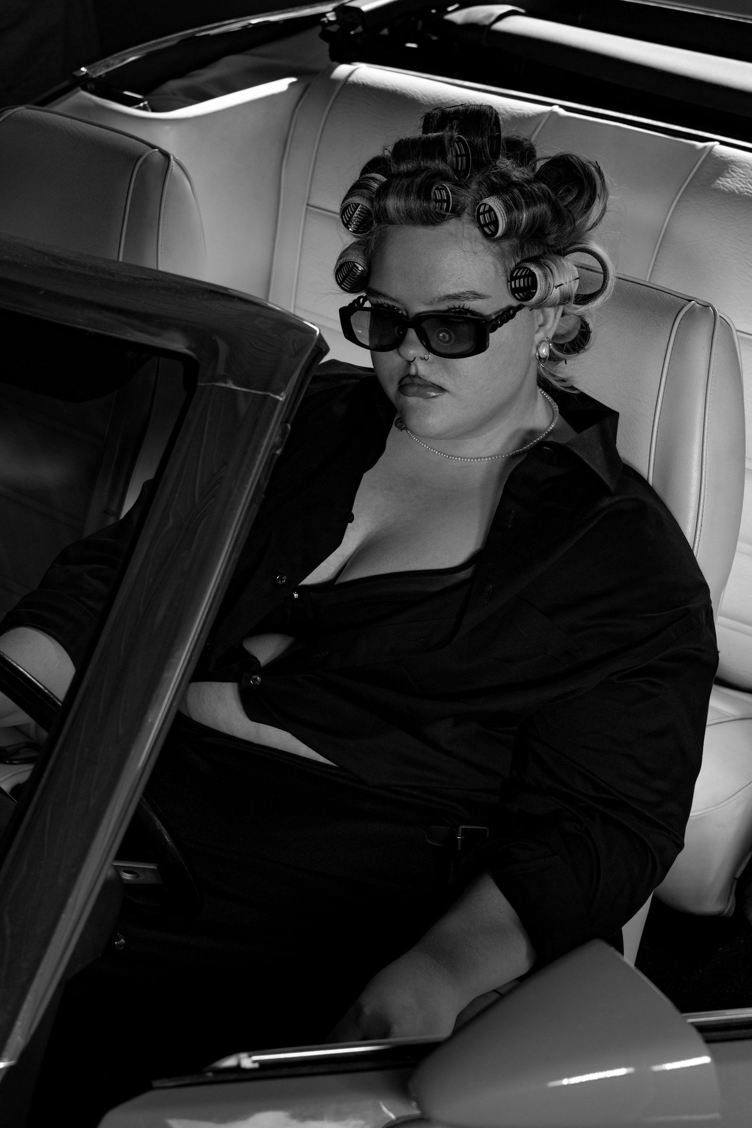 Female model sat in driver seat of 1971 ford Mustang