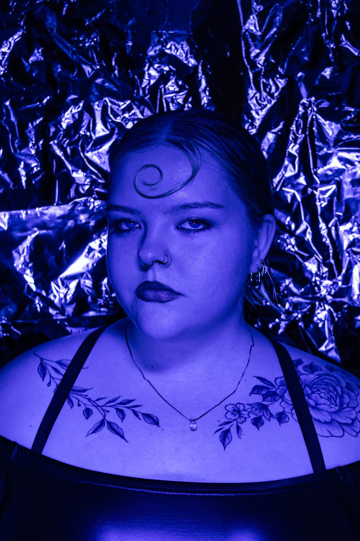 Female model headshot in violet light