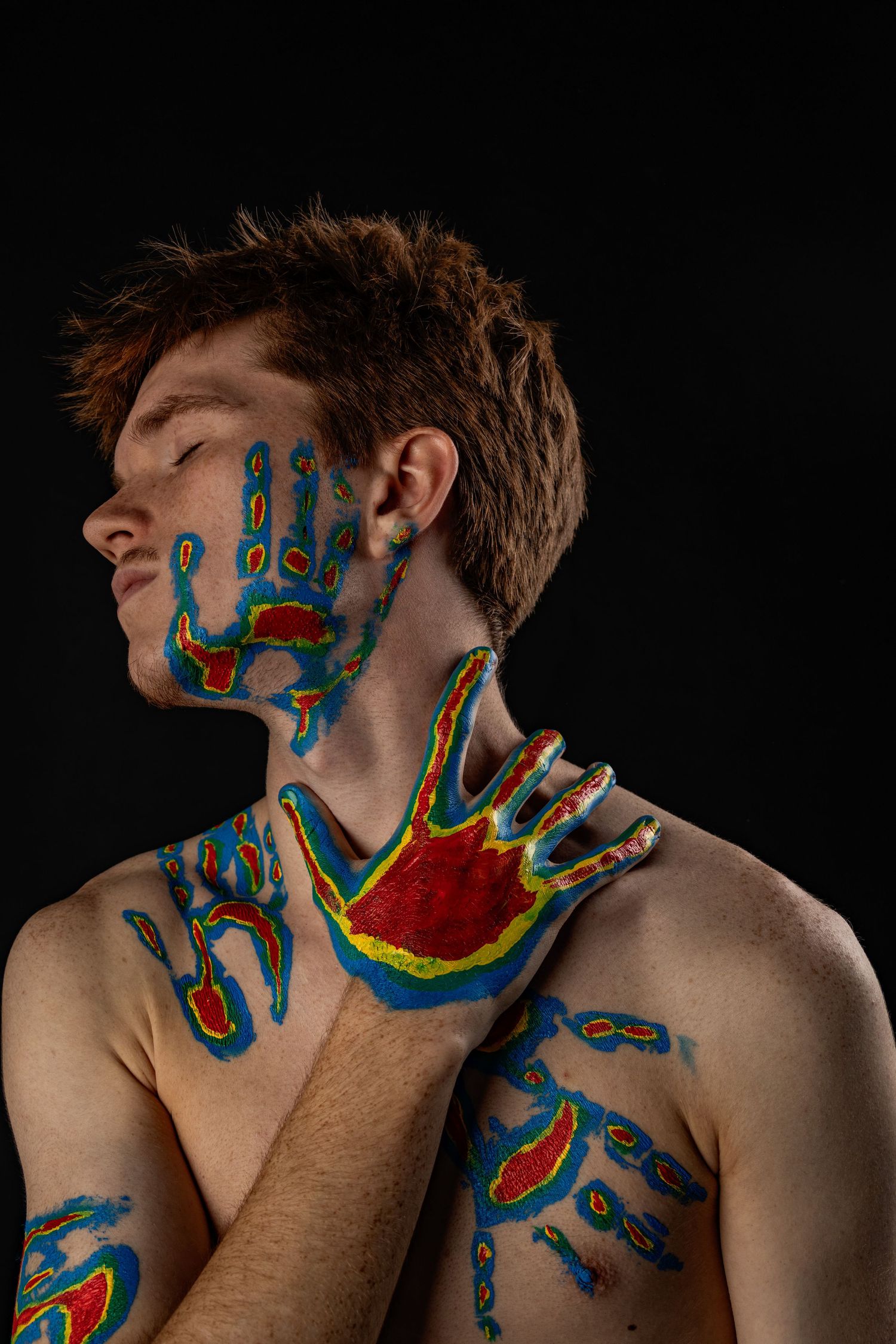 Male model with painted handprints on body