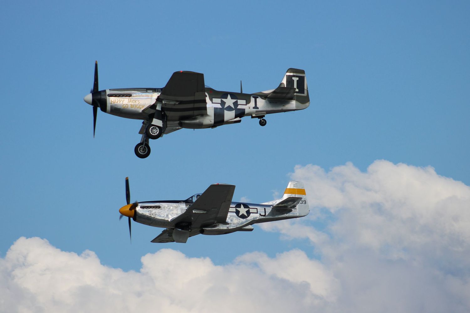 Two P-51 Mustangs flying in formation
