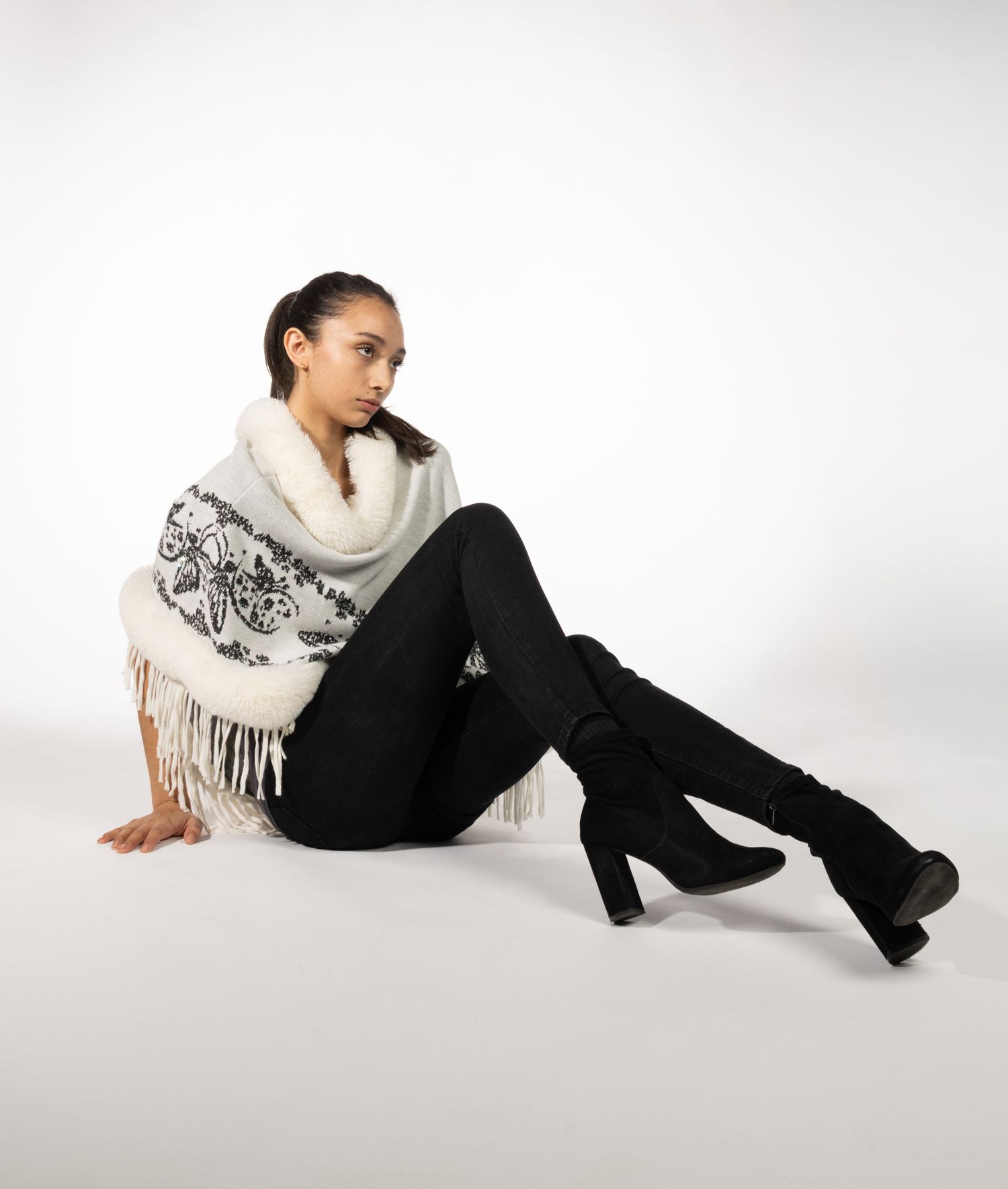 Female model posed sitting on white seamless background
