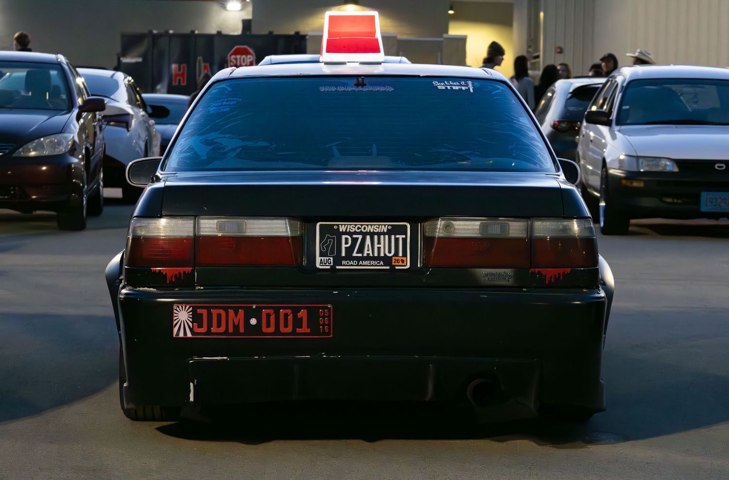 Back view of car with Pizza Hut hat and PZAHUT plate
