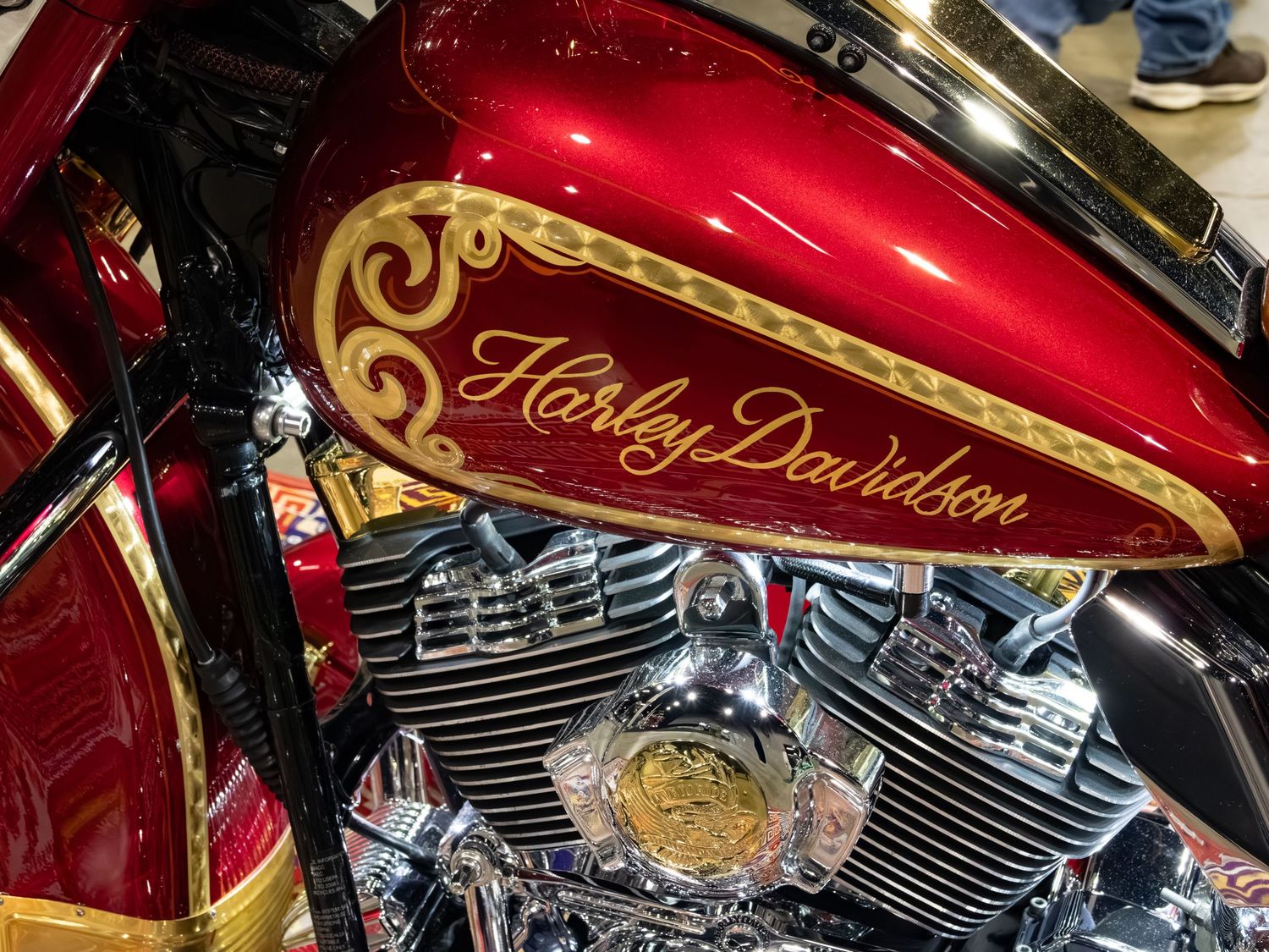 Harley Davidson logo in gold on red motorcycle