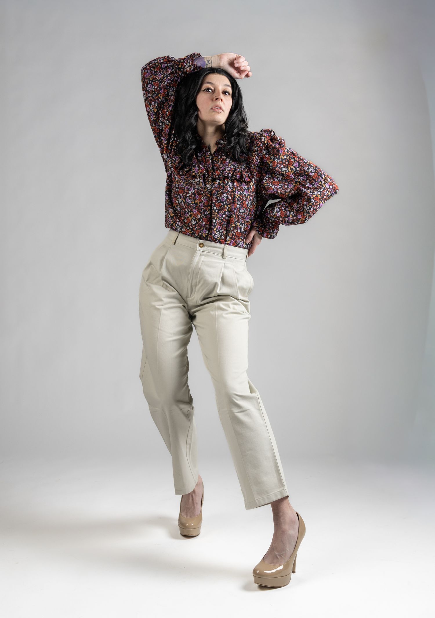 Female model posed standing in front of white seamless background