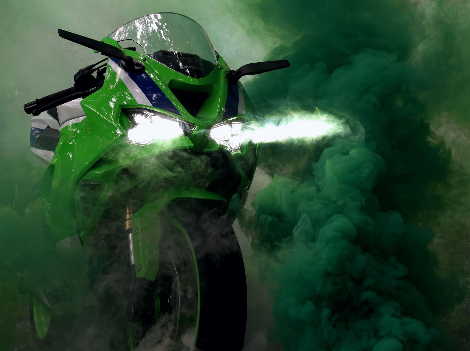 Green, white, and blue Kawasaki Ninja ZX-6R with green smoke
