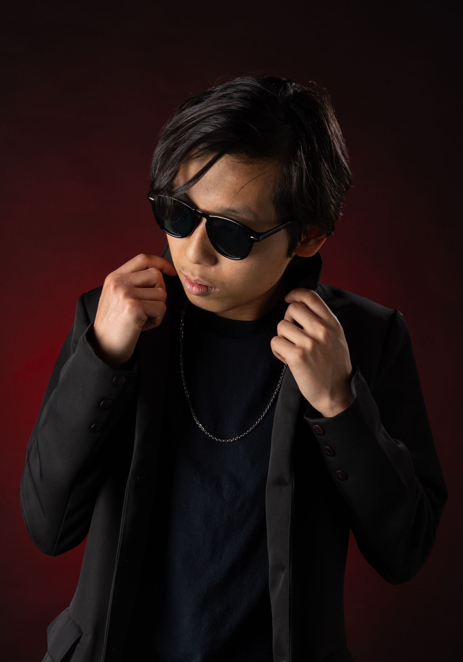 Male model portrait in front of red ombre background