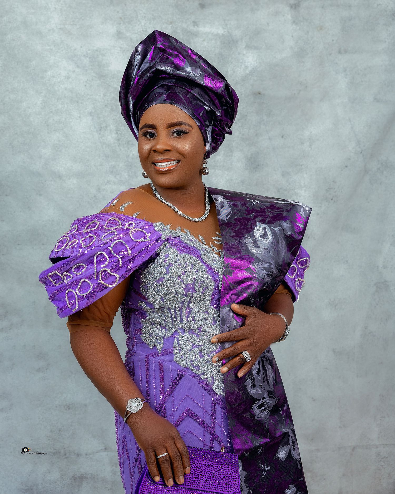 Stunning purple and silver embroidered traditional African dress with matching headwrap.