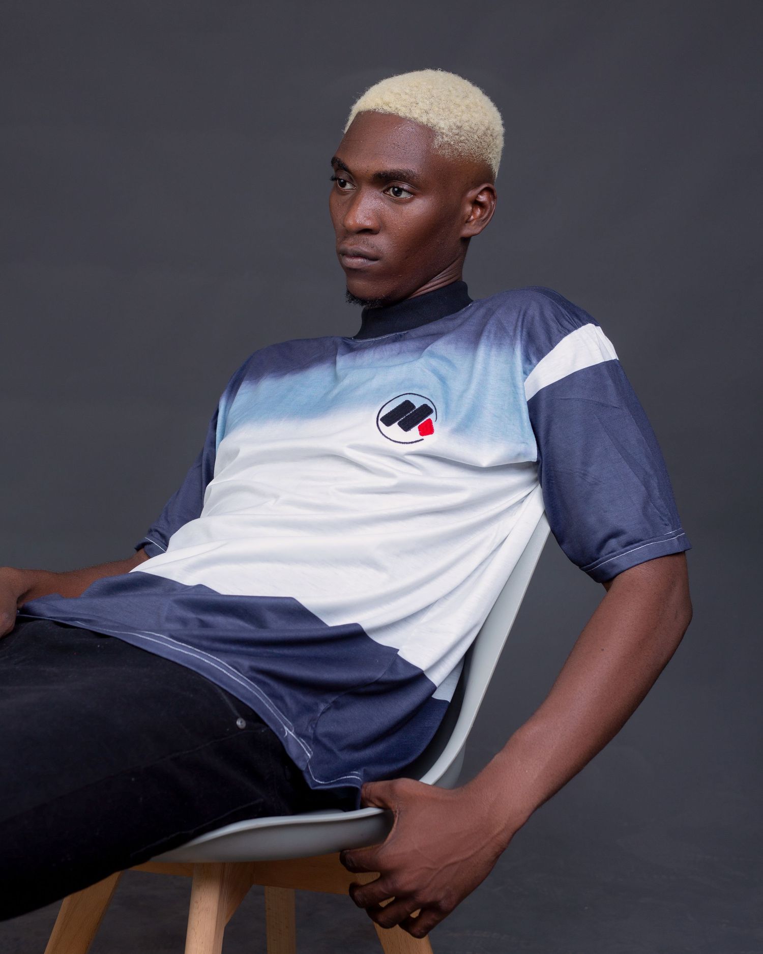 Athletic wear fashion shoot with navy and white color scheme against dark background.