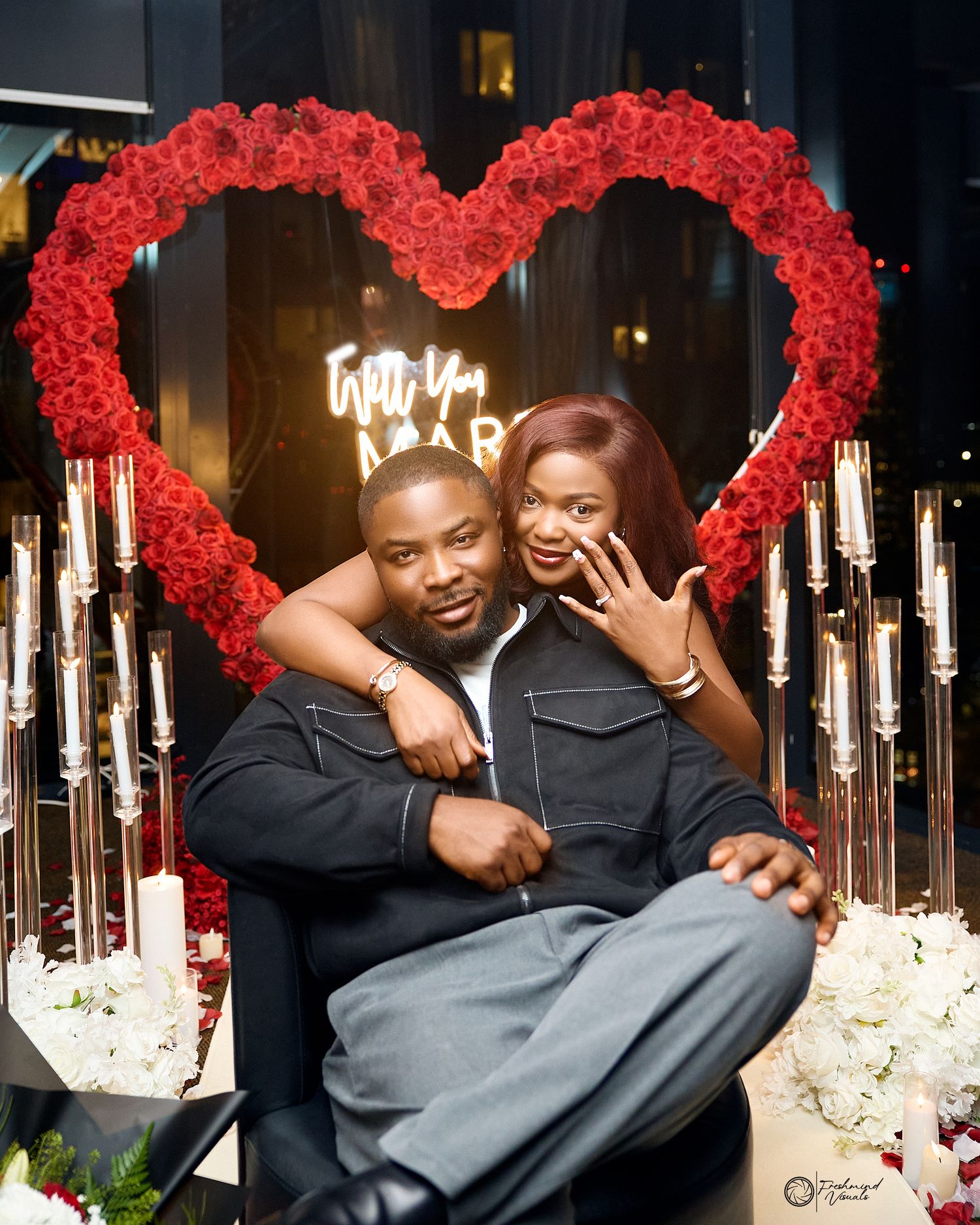 A romantic scene with red rose decor and candlelight during an intimate moment.