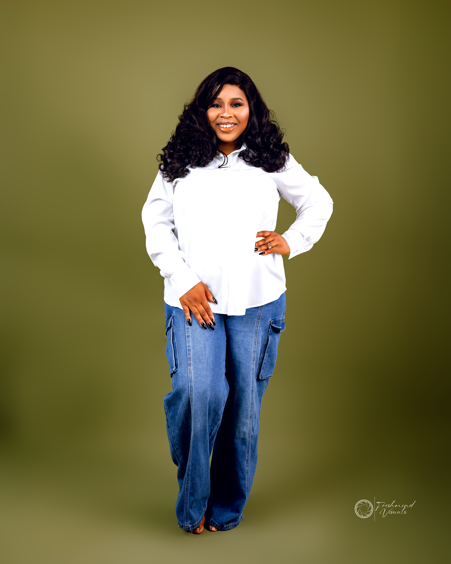Fashion portrait series in white ruffled top and denim against olive background.