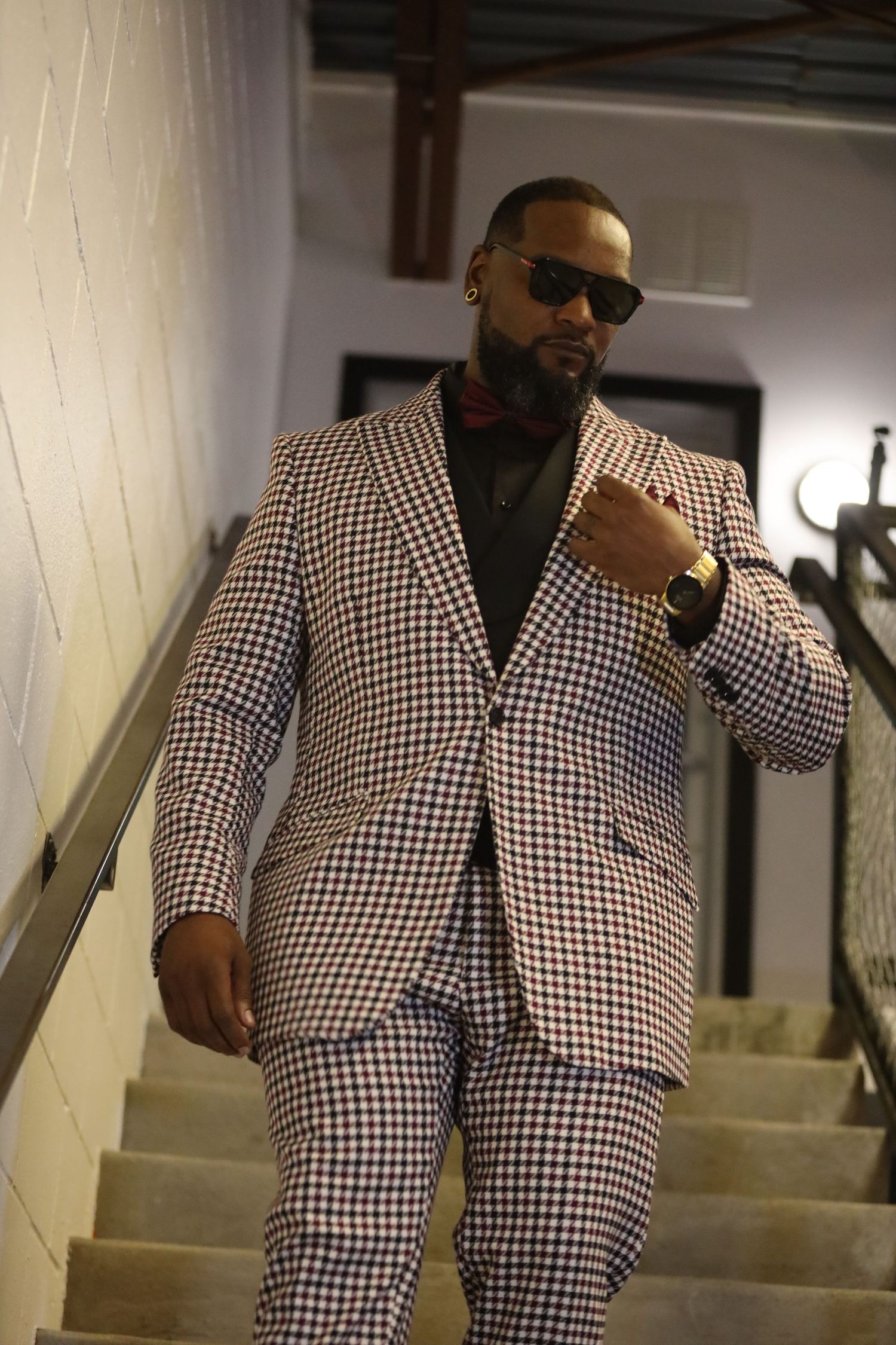 Black and white checkered suit ensemble photographed on staircase in multiple angles.