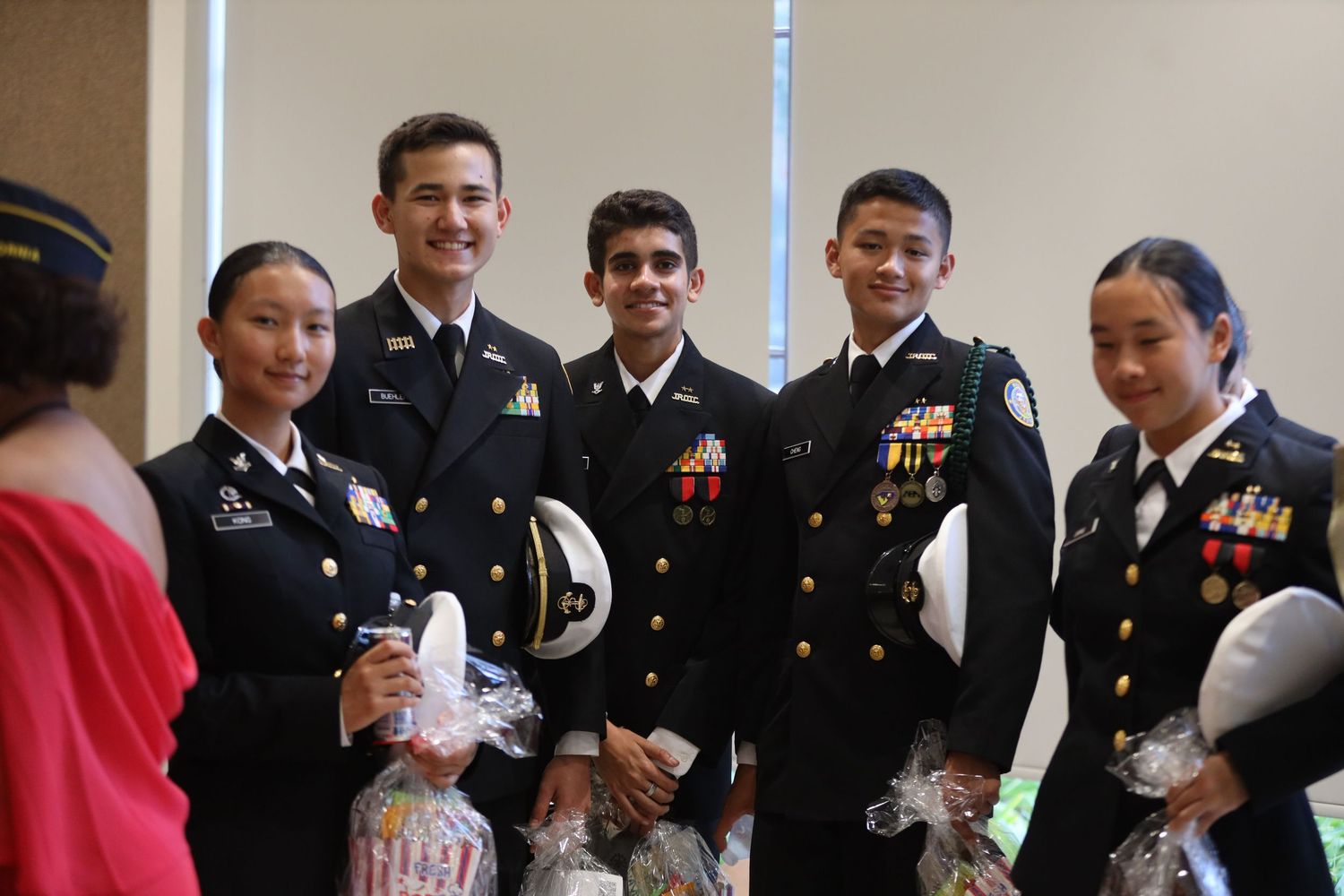 Military service members in dress uniforms gather at a formal event.