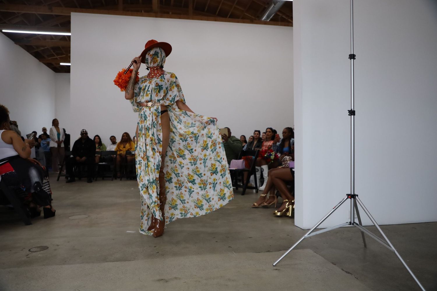 Gallery fashion show displays spring collection with floral prints and statement accessories.