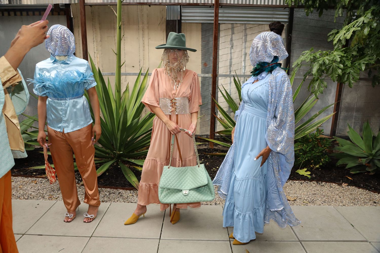Outdoor fashion presentation showcasing light summer dresses and casual wear.