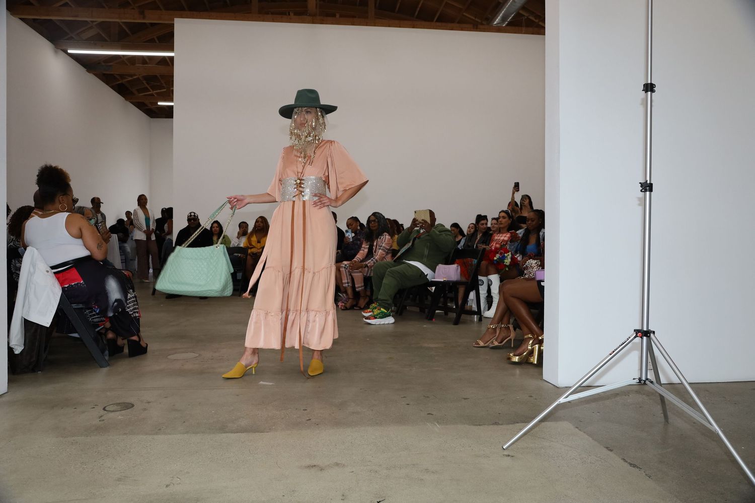 Fashion models showcase spring collection in industrial space with exposed ceiling and white walls.